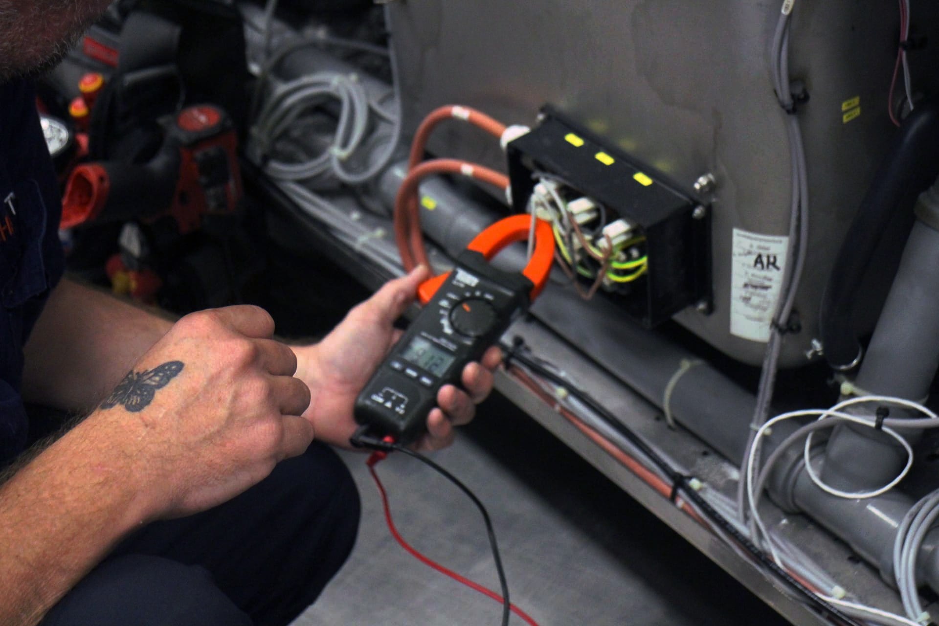 CHEFTECH technician clamp-meter testing commercial kitchen equipment on site