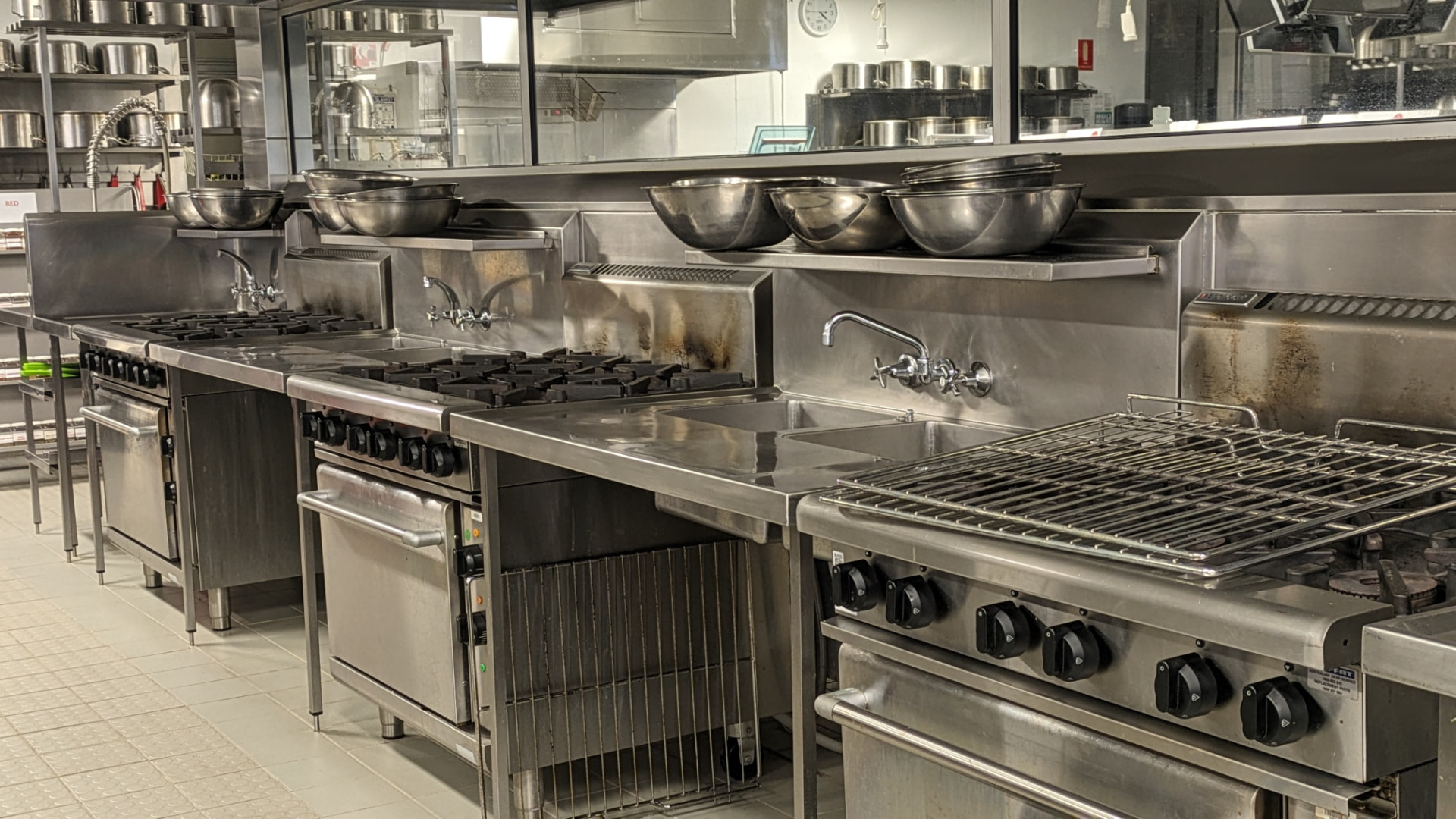 Commercial gas cooking line with ranges, ovens and chargrill serviced by CHEFTECH