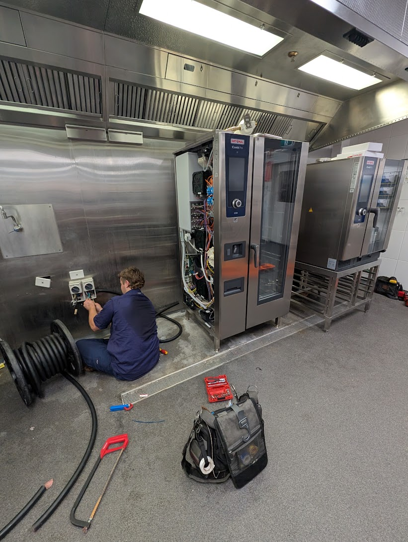 CHEFTECH technician installing a commercial combi oven on site